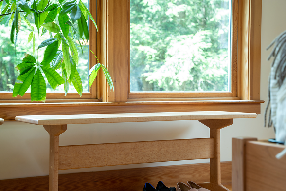 Bench under a window with womens shoes under it